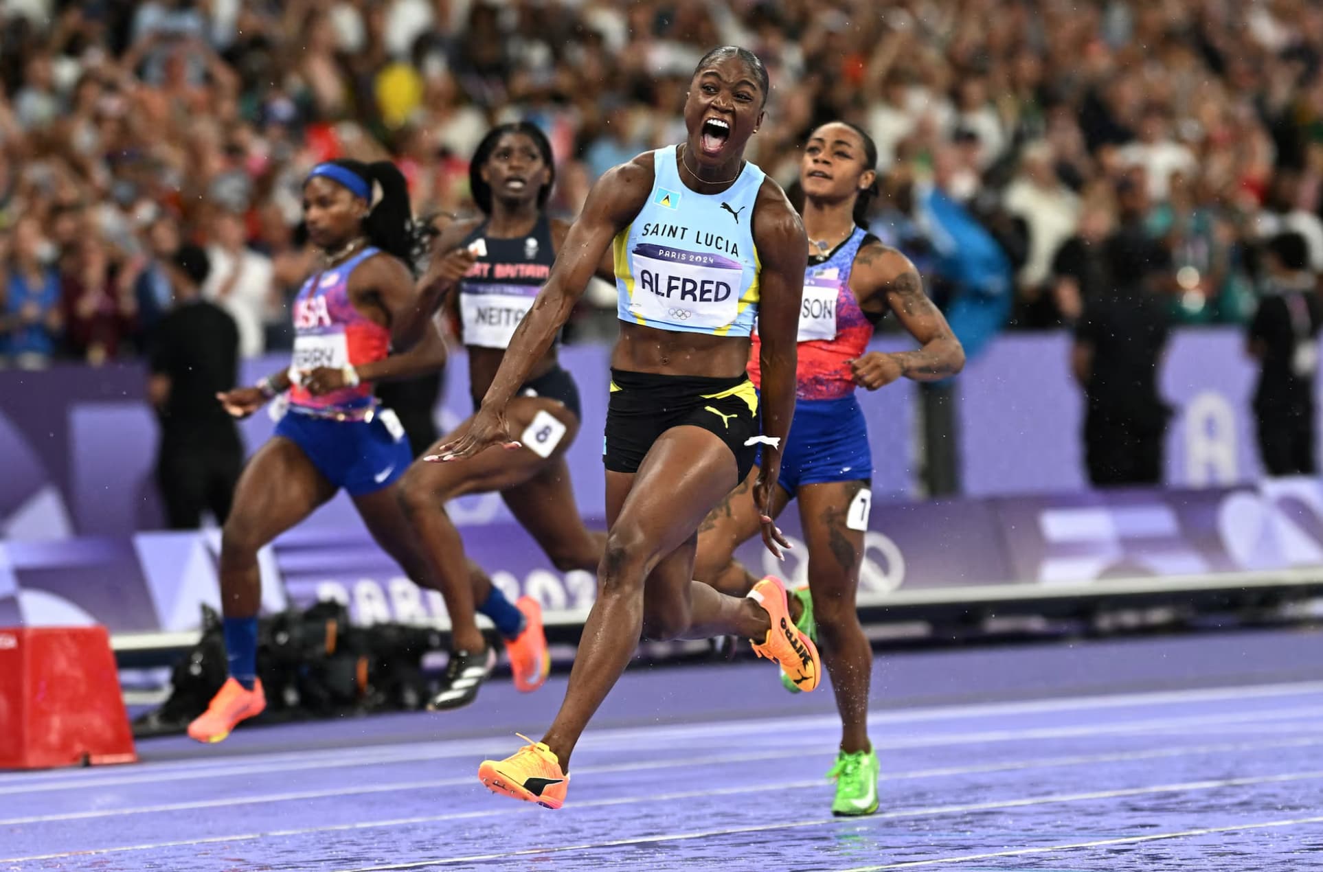 Saint Lucia’s Julien Alfred after taking gold in the women’s 100m.